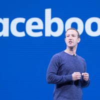 Mark Zuckerberg na tle logo Facebooka